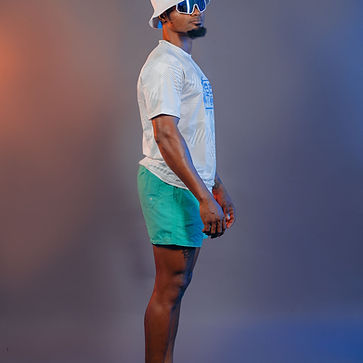 Rebel Nation male model in turquoise shorts and white t-shirt